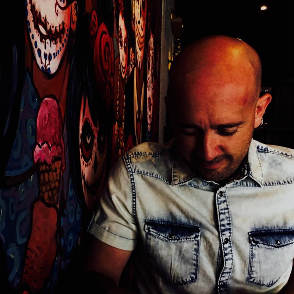 a man looking down at a wall with a painting