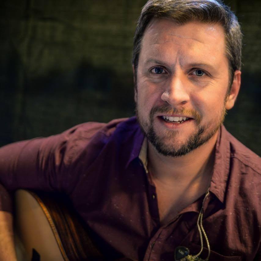 a man holding a guitar